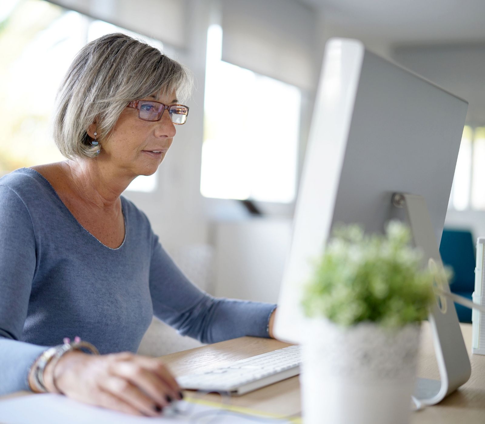 Woman working comfortably at her desktop computer, tech support made simple